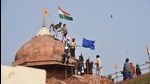 Farmers put up flags on a dome of Red Fort after their tractor parade on Republic Day, in New Delhi. (PTI) Farmers put up flags on a dome of Red Fort after their tractor parade on Republic Day, in New Delhi. (PTI)