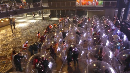 Staff inflate individual plastic bubbles, used as a safety measure against the coronavirus disease (via REUTERS)