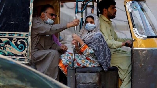 People with masks against COVID-19 travel by rikshaw (tok tok) in Karachi, Pakistan January 25, 2021. REUTERS/Akhtar Soomro/Files (REUTERS)