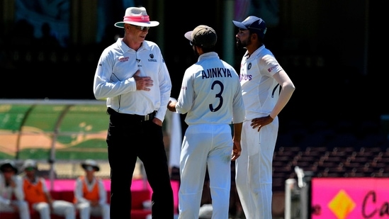 Ajinkya Rahane Mohammed Siraj to the umpire as the game was halted after allegedly some remarks were made by the spectators on the fourth day of the Sydney Test(AFP)