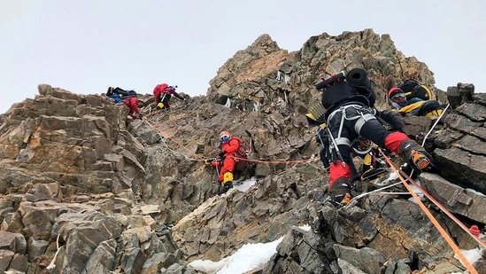 The mountaineers seen on their way to the summit of Mt K2. The exploits of the K2 team, which included Nirmal Purja, who last year smashed the speed record for summiting the world's 14 highest peaks, reflect a changing approach of modern-day Nepali climbers.(Seven Summit Treks / AFP)