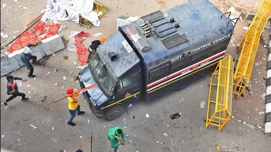 Farmers vandalise a police vehicle following clashes with Delhi Police during the tractor march, at Nangloi Crossing, in New Delhi on January 26. (Raj K Raj/HT photo)