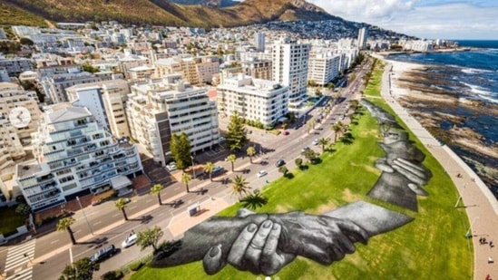 "The idea is to create the biggest human chain, to speak about togetherness and today in Cape Town this is the ninth step of that project," Saype, who was born Guillaume Legros. (Reuters) "The idea is to create the biggest human chain, to speak about togetherness and today in Cape Town this is the ninth step of that project," Saype, who was born Guillaume Legros. (Reuters)