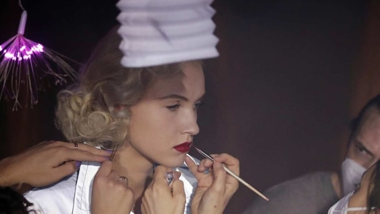 Model Michaela Tomanova has her makeup retouched during the shoot for Julien Fournie’s Haute Couture Spring/Summer 2021 fashion collection for a digital presentation of the fashion week, in Paris, Thursday, Jan. 7, 2021. (AP)