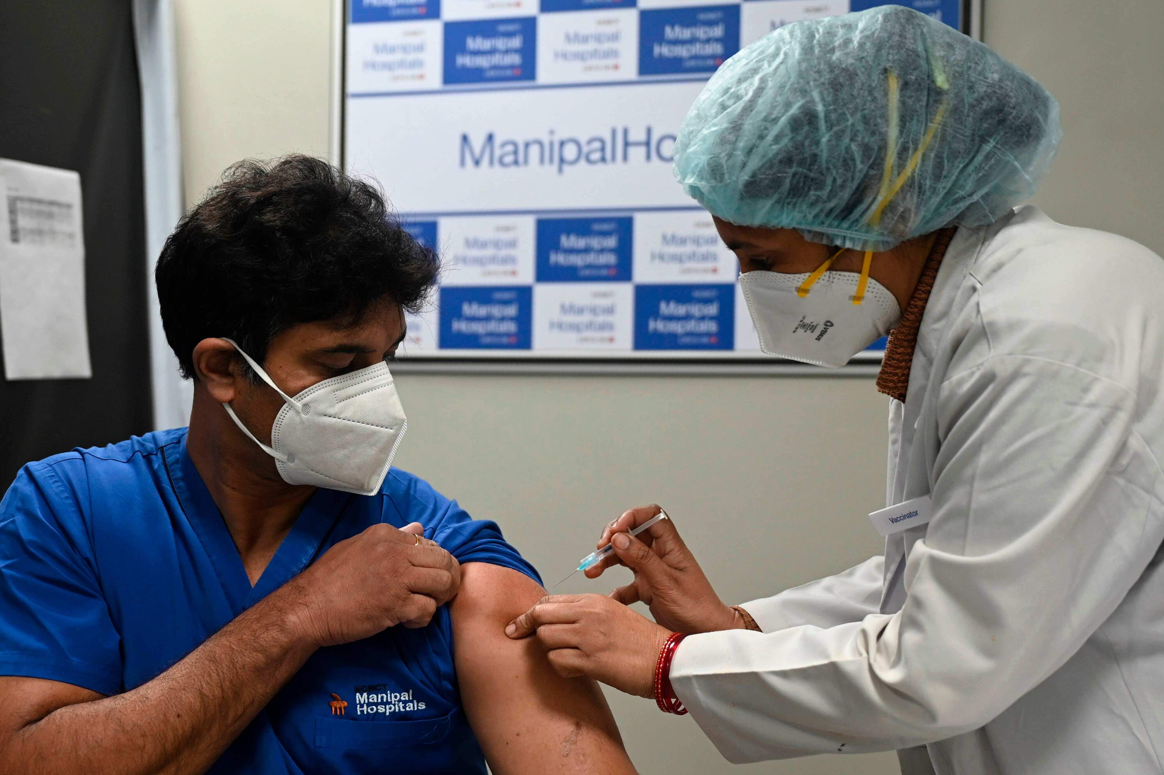A medical worker (R) inoculates a medical staff with a Covid-19 coronavirus vaccine at the Manipal Hospital, in New Delhi on January 19, 2021. (Photo by Money SHARMA / AFP) (AFP) A medical worker (R) inoculates a medical staff with a Covid-19 coronavirus vaccine at the Manipal Hospital, in New Delhi on January 19, 2021. (Photo by Money SHARMA / AFP) (AFP)