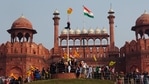 A man hangs on to pole holding a Sikh religious flag along with a farm union flag at the historic Red Fort monument during a farmers protest against new farm laws in New Delhi, India. A sea of tens of thousands of farmers riding tractors and horses stormed India’s historic Red Fort this week — a dramatic escalation of their protests. (AP) A man hangs on to pole holding a Sikh religious flag along with a farm union flag at the historic Red Fort monument during a farmers protest against new farm laws in New Delhi, India. A sea of tens of thousands of farmers riding tractors and horses stormed India’s historic Red Fort this week — a dramatic escalation of their protests. (AP)