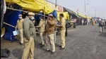 Police personnel arrive at Ghazipur border to hang notices for farmer leaders after FIRs were registered against them in connection with the Republic Day violence, during the ongoing protest against the new farm laws, in New Delhi, Thursday. (PTI) Police personnel arrive at Ghazipur border to hang notices for farmer leaders after FIRs were registered against them in connection with the Republic Day violence, during the ongoing protest against the new farm laws, in New Delhi, Thursday. (PTI)