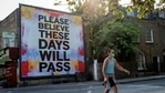 A pedestrian walks past a billboard reading "Please believe these days will pass" on Broadway Market in east London.(AFP File Photo ) A pedestrian walks past a billboard reading "Please believe these days will pass" on Broadway Market in east London.(AFP File Photo )