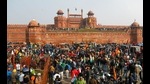 Farmers in front of the Red Fort and hoist the Khalsa flag during the protest against the Centre’s farm laws on Republic Day. (Reuters file photo) Farmers in front of the Red Fort and hoist the Khalsa flag during the protest against the Centre’s farm laws on Republic Day. (Reuters file photo)
