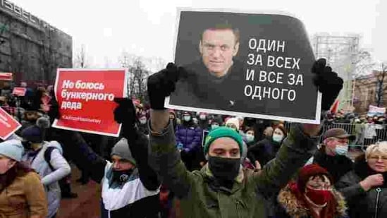 A participant holds a placard reading "One for all, all for one" during a rally in support of jailed Russian opposition leader Alexei Navalny.(REUTERS)