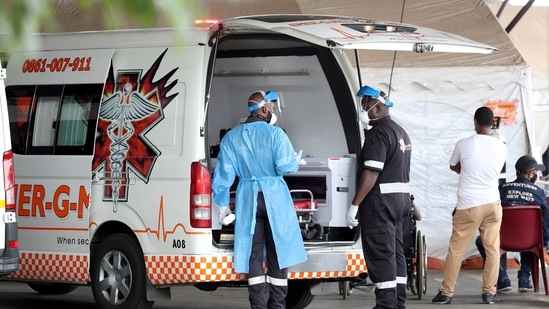 Health workers chat near an ambulance at the parking lot of the Steve Biko Academic Hospital, amid a nationwide coronavirus disease (Covid-19) lockdown, in Pretoria, South Africa.(Reuters)