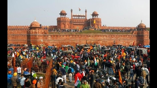 Farmers in front of the Red Fort and hoist the Khalsa flag during the protest against the Centre’s farm laws on Republic Day. (Reuters file photo) Farmers in front of the Red Fort and hoist the Khalsa flag during the protest against the Centre’s farm laws on Republic Day. (Reuters file photo)
