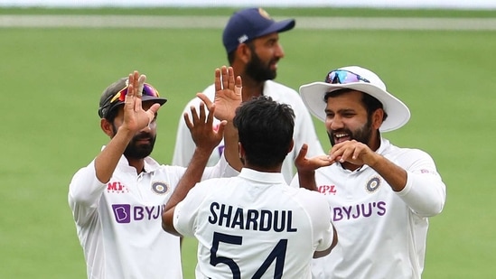 India's Ajinkya Rahane, left, and India's Rohit Sharma, right, congratulate teammate Shardul Thakur, centre, after dismissing Australia's Tim Paine during play on day four of the fourth cricket test between India and Australia at the Gabba, Brisbane, Australia, Monday, Jan. 18, 2021. (AP Photo/Tertius Pickard) (AP) India's Ajinkya Rahane, left, and India's Rohit Sharma, right, congratulate teammate Shardul Thakur, centre, after dismissing Australia's Tim Paine during play on day four of the fourth cricket test between India and Australia at the Gabba, Brisbane, Australia, Monday, Jan. 18, 2021. (AP Photo/Tertius Pickard) (AP)