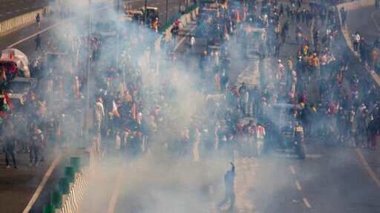 FILE - In this Tuesday, Jan. 26, 2021, file photo, protesting farmers are seen amid tear gas smoke fired by police in an attempt to stop them from marching to the capital during India's Republic Day celebrations in New Delhi, India. A sea of tens of thousands of farmers riding tractors and horses stormed India’s historic Red Fort this week, a dramatic escalation of their protests, which are posing a major challenge to Prime Minister Narendra Modi’s government. (AP Photo/Altaf Qadri, File)(AP) FILE - In this Tuesday, Jan. 26, 2021, file photo, protesting farmers are seen amid tear gas smoke fired by police in an attempt to stop them from marching to the capital during India's Republic Day celebrations in New Delhi, India. A sea of tens of thousands of farmers riding tractors and horses stormed India’s historic Red Fort this week, a dramatic escalation of their protests, which are posing a major challenge to Prime Minister Narendra Modi’s government. (AP Photo/Altaf Qadri, File)(AP)