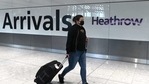 (FILES) In this file photo taken on July 10, 2020 a passenger wearing a face mask or covering due to the Covid-19 pandemic, arrives at Heathrow airport, west London. - Britain's Transport Secretary Grant Shapps set out new rules which, from next week, will require passengers arriving in England by boat, train or plane - including UK nationals - to take a test up to 72 hours before leaving the country of departure. Failure to comply will lead to an immediate £500 fine.(AFP) (FILES) In this file photo taken on July 10, 2020 a passenger wearing a face mask or covering due to the Covid-19 pandemic, arrives at Heathrow airport, west London. - Britain's Transport Secretary Grant Shapps set out new rules which, from next week, will require passengers arriving in England by boat, train or plane - including UK nationals - to take a test up to 72 hours before leaving the country of departure. Failure to comply will lead to an immediate £500 fine.(AFP)