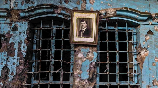 A portrait of an Iraqi man hangs on the wall of a heavily damaged house in the Old City of Mosul on January 26, 2021. Once the historic heart of Iraq's Mosul, the Old City has lain in ruins for years.(Zaid AL-Obeidi / AFP)