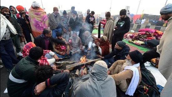 Farmers sit around a bonfire to warm themwselves on a cold morning during their ongoing protest against the new farm laws, at Ghazipur border in New Delhi on January 29. (PTI) Farmers sit around a bonfire to warm themwselves on a cold morning during their ongoing protest against the new farm laws, at Ghazipur border in New Delhi on January 29. (PTI)