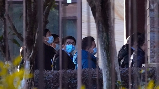 Chinese counterparts arrive at conference area of the hotel where the World Health Organization team is staying in Wuhan on Friday, Jan. 29, 2021. (AP) Chinese counterparts arrive at conference area of the hotel where the World Health Organization team is staying in Wuhan on Friday, Jan. 29, 2021. (AP)
