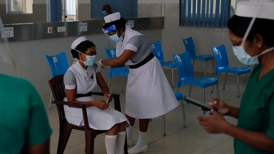 A Sri Lankan nurse administers the COVID-19 vaccine to another in Colombo, Sri Lanka, Friday, Jan. 29, 2021. (AP) A Sri Lankan nurse administers the COVID-19 vaccine to another in Colombo, Sri Lanka, Friday, Jan. 29, 2021. (AP)