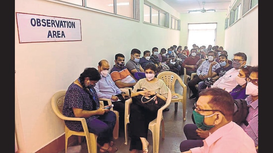 Vaccine beneficiaries wait at the observation room after getting the vaccine at BYL Nair Hospital. (Anshuman Poyrekar/HT Photo)