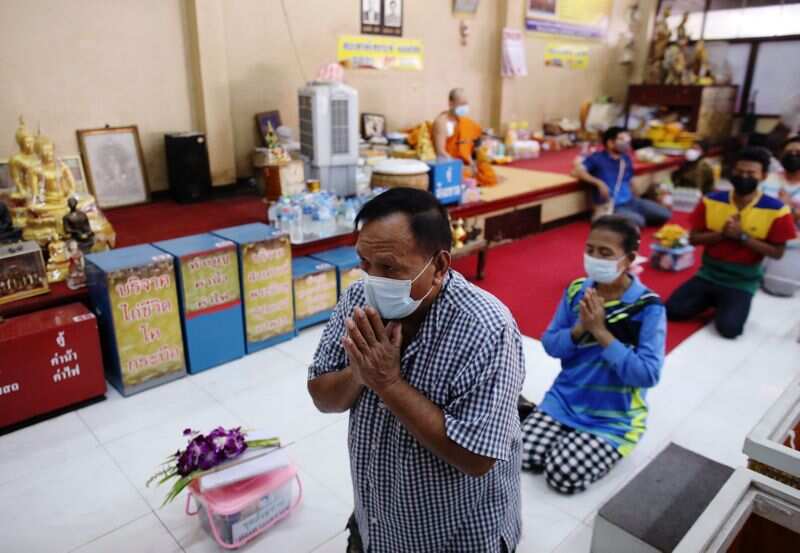 Devotees pray before lying down inside coffins to trick death and improve their luck at a temple in Bangkok, Thailand. (REUTERS)