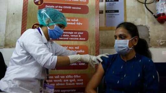 A health worker administers a Covid-19 vaccine to a hospital staff at a vaccination centre in Ahmedabad in this file photo. (AP) A health worker administers a Covid-19 vaccine to a hospital staff at a vaccination centre in Ahmedabad in this file photo. (AP)