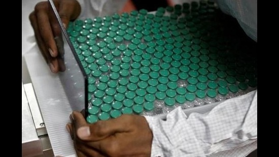 An employee in personal protective equipment (PPE) removes vials of AstraZeneca's COVISHIELD, coronavirus disease (COVID-19) vaccine from a visual inspection machine inside a lab at Serum Institute of India. (REUTERS) An employee in personal protective equipment (PPE) removes vials of AstraZeneca's COVISHIELD, coronavirus disease (COVID-19) vaccine from a visual inspection machine inside a lab at Serum Institute of India. (REUTERS)