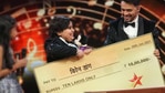 Biren Dang lifting up his cheque. Biren Dang lifting up his cheque.