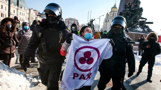Police detain a woman during a protest against the jailing of opposition leader Alexei Navalny in Russia. (AP) Police detain a woman during a protest against the jailing of opposition leader Alexei Navalny in Russia. (AP)