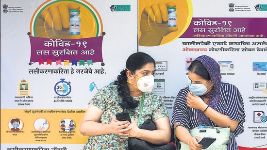 Health workers seated outside a vaccine centre at Rajawadi Hospital on Saturday. (Satish Bate/HT Photo)