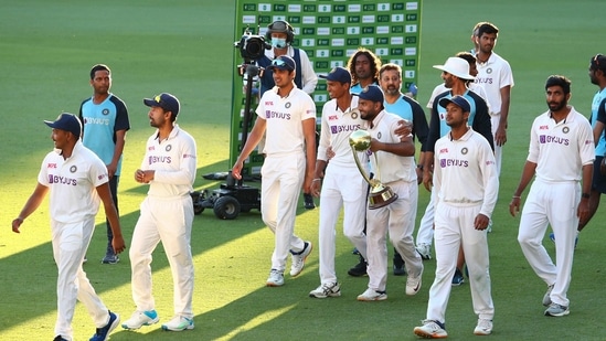 Indian players celebrate with their trophy after defeating Australia by three wickets on the final day of the fourth cricket Test at the Gabba, Brisbane,(AP)