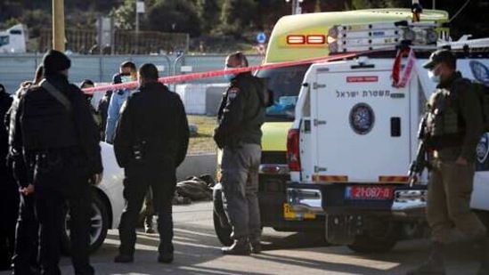 Israeli soldiers stand next to the body of a Palestinian at the scene of an attack near the West Bank settlement of Gush Etzion. (AP) Israeli soldiers stand next to the body of a Palestinian at the scene of an attack near the West Bank settlement of Gush Etzion. (AP)