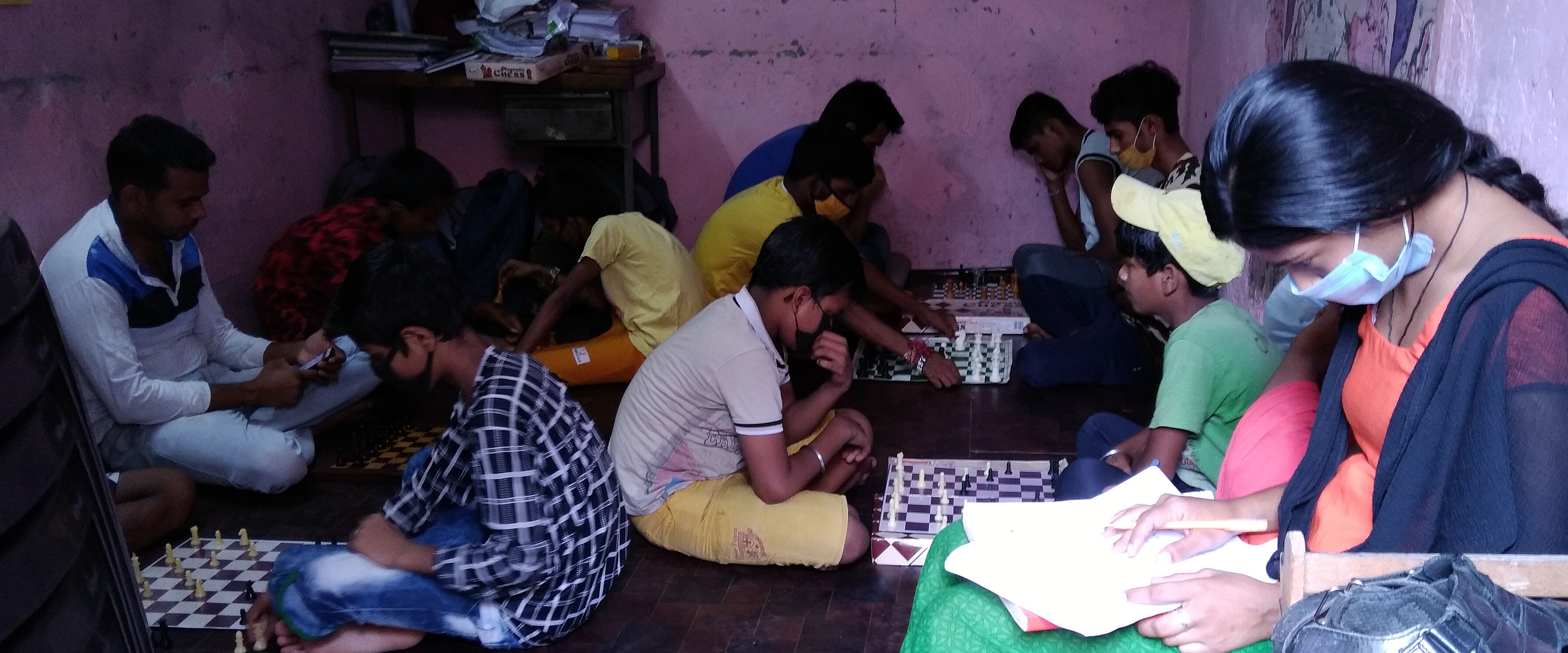 Youngsters read and play games at one of the libraries set up by the DU students in a slum cluster.