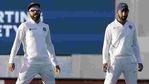 India's Virat Kohli, left, stands with teammate Cheteshwar Pujara during play on day one of the second cricket test between New Zealand and India at Hagley Oval in Christchurch. (AP)