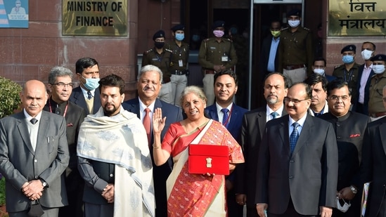 Union Minister of Finance Nirmala Sitharaman holds a case containing a tablet device, instead of the “bahi khata” seen in recent years, before heading to present the Union Budget 2021-22, at Ministry of Finance in New Delhi on February 1. This year marks the first time a paperless budget document was presented in Parliament.(Ajay Aggarwal / HT Photo)