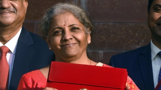 Union Minister for Finance and Corporate Affairs, Nirmala Sitharaman shows the Made-in-India tab through which the budget will be presented as she leaves from Ministry of Finance to present the Union Budget 2021-22 in the Parliament, in New Delhi.(ANI)