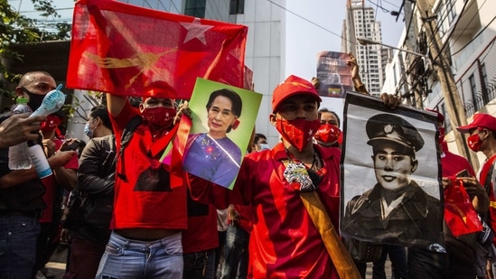 Demonstrators hold up images of Aung San Suu Kyi during a protest outside the Embassy of Myanmar in Bangkok, Thailand.(Bloomberg)