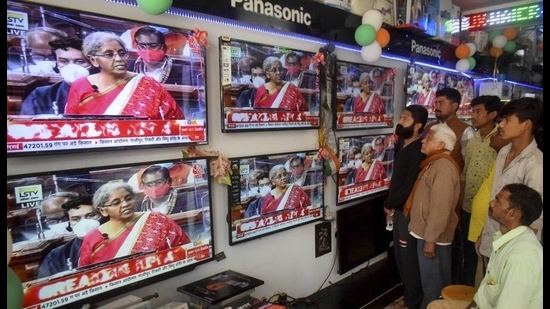 People watch finance minister Nirmala Sitharaman present the Union Budget 2021-21, Prayagraj, February 1, 2021 (PTI) People watch finance minister Nirmala Sitharaman present the Union Budget 2021-21, Prayagraj, February 1, 2021 (PTI)