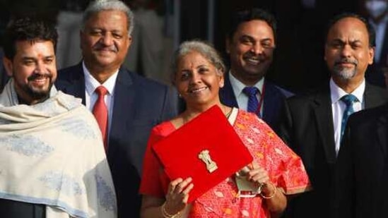 Finance Minister Nirmala Sitharaman, center, with junior Finance Minister Anurag Thakur, left, leave finance ministry for the parliament house to present annual federal budget, in New Delhi, India, Monday, Feb. 1, 2021.(AP)