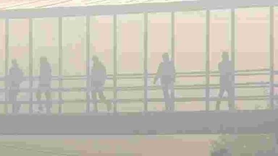 Commuters crossing a foot over bridge amid dense fog on a cold winter day, at IFFCO Chowk in Gurugram on December 24. North-western India, including Delhi, Noida and Ghaziabad, mostly recorded “very poor” to “severe” air quality on December 25 amid a drop in wind speed that has slowed down the dispersal of pollutants. (PTI) Commuters crossing a foot over bridge amid dense fog on a cold winter day, at IFFCO Chowk in Gurugram on December 24. North-western India, including Delhi, Noida and Ghaziabad, mostly recorded “very poor” to “severe” air quality on December 25 amid a drop in wind speed that has slowed down the dispersal of pollutants. (PTI)
