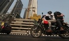 A man rides past buildings under construction in Mumbai. (AP Photo) A man rides past buildings under construction in Mumbai. (AP Photo)