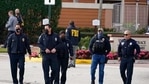 Law enforcement officers walk near the entrance to an apartment complex where a shooting wounded several FBI agents while serving an arrest warrant.(AP) Law enforcement officers walk near the entrance to an apartment complex where a shooting wounded several FBI agents while serving an arrest warrant.(AP)