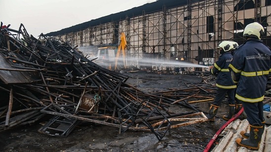 Fire brigade personnel try to douse a fire that broke out at a film set in Goregaon West, Mumbai. (PTI)