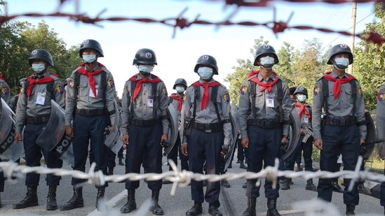 Police stand guard behind barbed wire as they attempt to stop protesters outside Union Election Commission office in Naypyitaw,(AP)