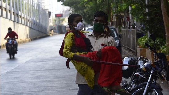 Patients like Aachal Gowde (carried by her father Ravindra Kumar) were unable to get proper transport to and from Tata Memorial Hospital during the Covid-19 lockdown. (Anshuman Poyrekar/HT Photo)