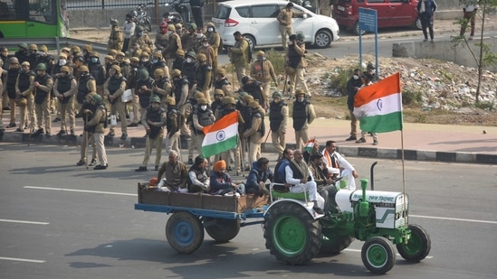 Farmers during the tractor rally against the new farm laws, near Akshardham in New Delhi on January 26. Since the tractor rally on January 26 went out of control, the farmers’ protest in Delhi borders has witnessed severe police arrangements and leaders calling for support to continue the agitation against the new farm laws.(Sanchit Khanna / HT Photo)