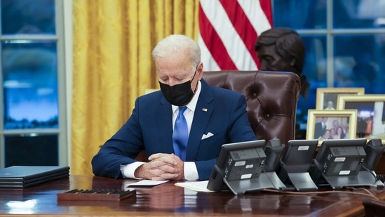 US President Joe Biden signs executive actions in the Oval Office of the White House in Washington, DC, US, on Tuesday. (Bloomberg File Photo ) US President Joe Biden signs executive actions in the Oval Office of the White House in Washington, DC, US, on Tuesday. (Bloomberg File Photo )