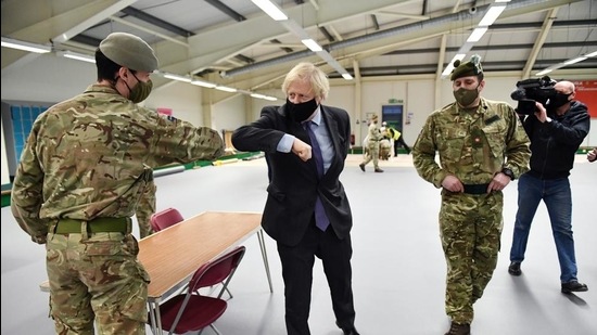British Prime Minister Boris Johnson meets troops as they set up a vaccination centre in the Castlemilk district of Glasgow, Scotland, Britain on January 28, 2021. (REUTERS) British Prime Minister Boris Johnson meets troops as they set up a vaccination centre in the Castlemilk district of Glasgow, Scotland, Britain on January 28, 2021. (REUTERS)
