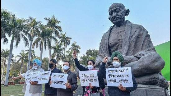 MPs from Punjab hold placards during their protest against the new farm laws, at Parliament House in New Delhi, Tuesday. (PTI)