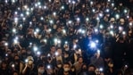 Pro-democracy protesters flash their smartphone lights as they gather on a street in Hong Kong on February 2, 2021. (AP)